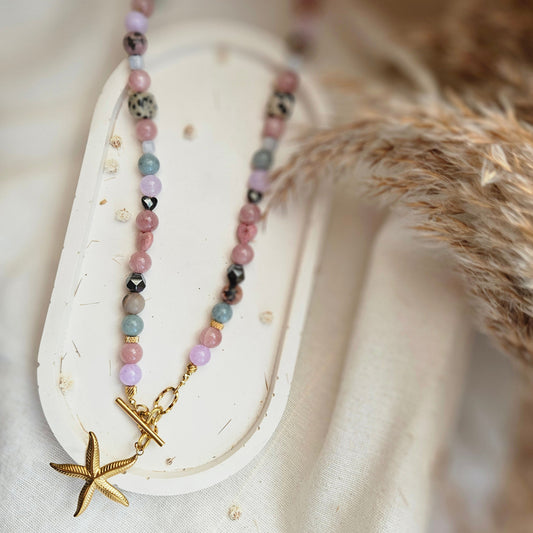 Pink and mixed stone bead necklace with a starfish pendant, dalmatian jasper, black hematite and stainless steel details.
