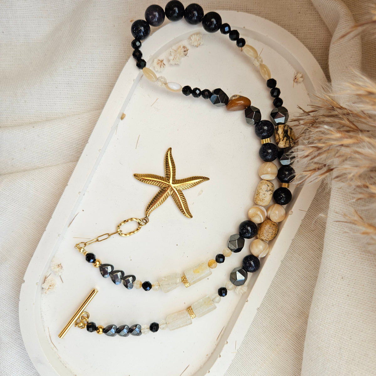 Black and yellow mixed stone necklace with a starfish pendant, citrine, landscape jasper, black tourmaline, Blue Goldstone, hematite and stainless steel details.
