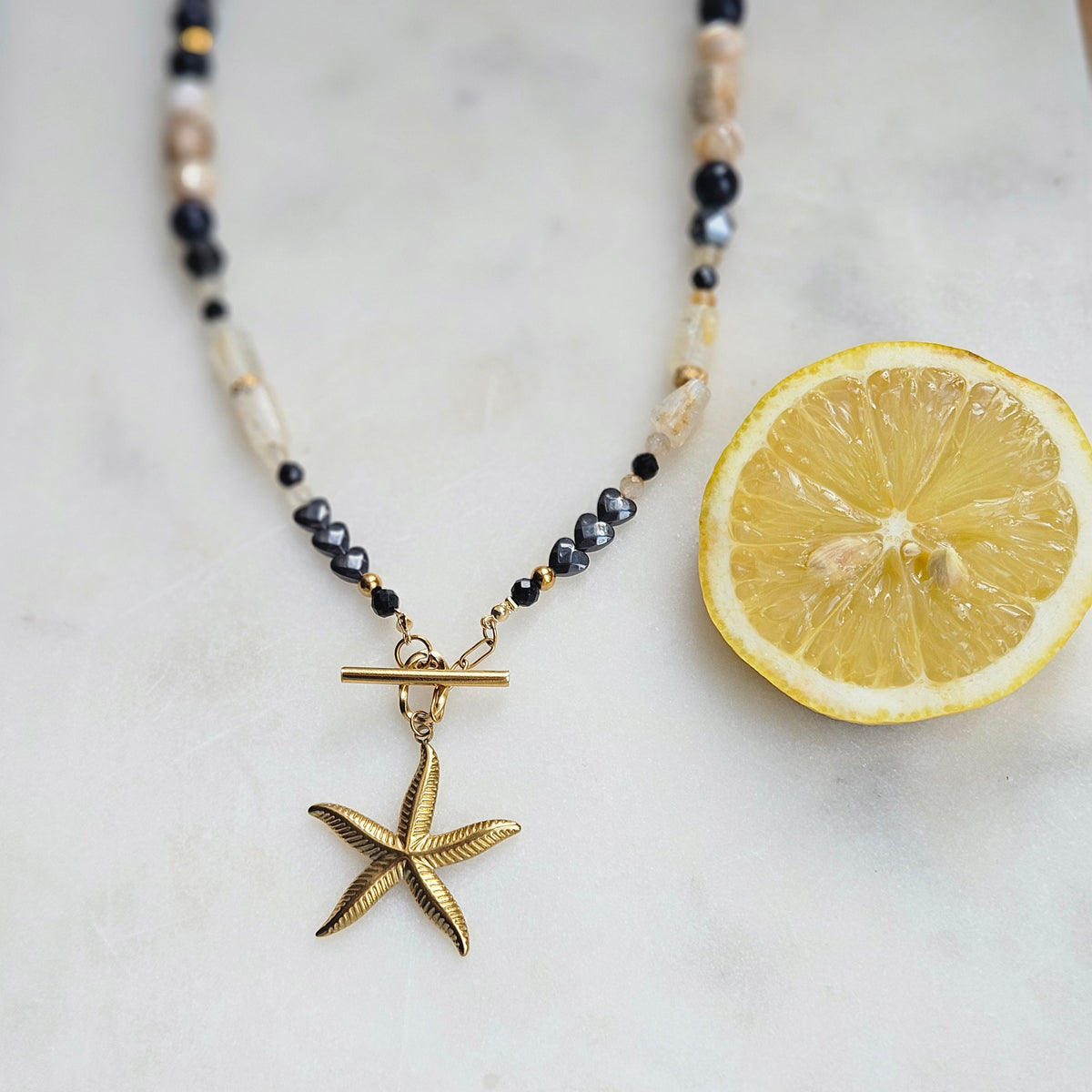Black and yellow mixed stone necklace with a starfish pendant, citrine, landscape jasper, black tourmaline, Blue Goldstone, hematite and stainless steel details.