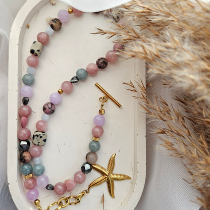 Pink and mixed stone bead necklace with a starfish pendant, dalmatian jasper, black hematite and stainless steel details.