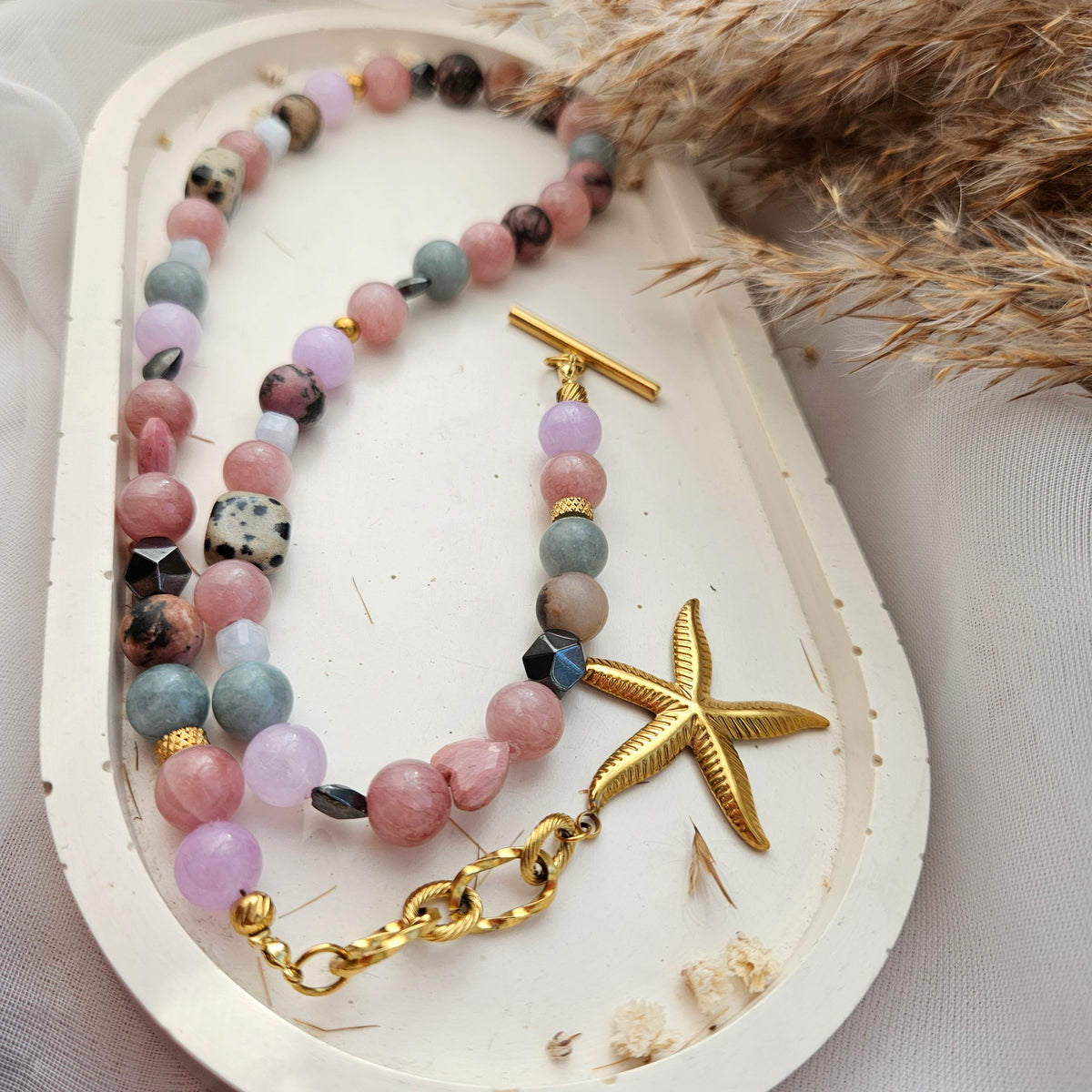 Pink and mixed stone bead necklace with a starfish pendant, dalmatian jasper, black hematite and stainless steel details.