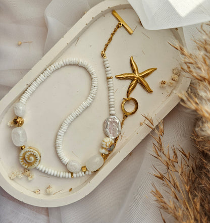 White beaded necklace with a starfish pendant, white howlite, shell beads, white jade and silver-tone stainless steel details.