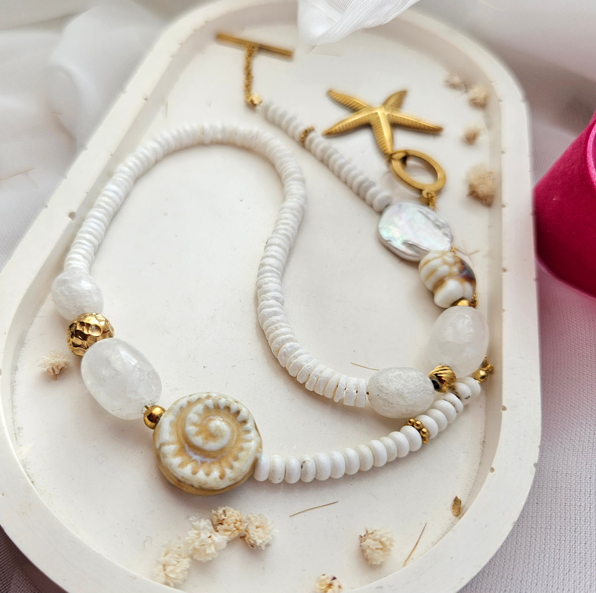 White beaded necklace with a starfish pendant, white howlite, shell beads, white jade and silver-tone stainless steel details.
